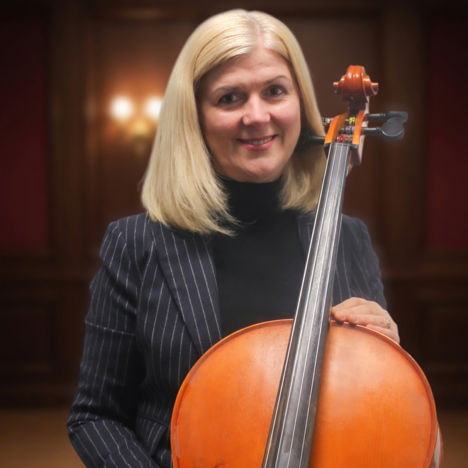 Elvira Lagji, European-trained cello teacher, holding her cello